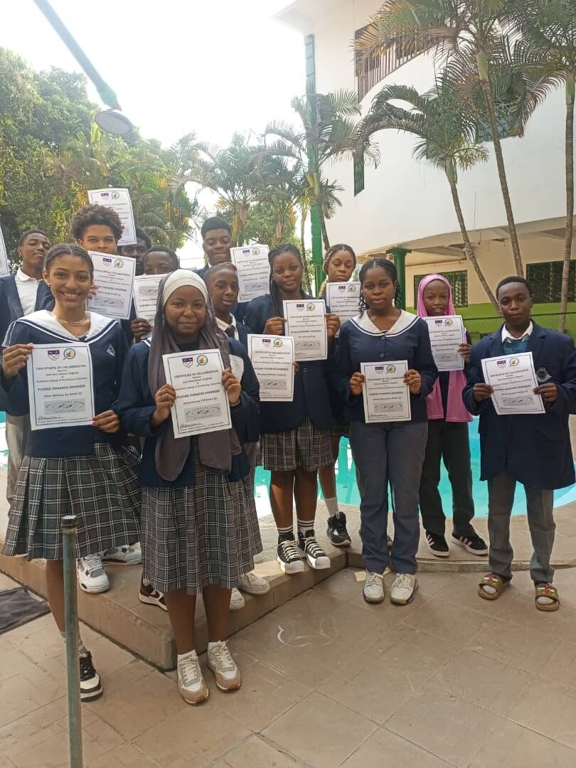 Students from the Academic College of Excellence in Cameroon stood holding certificates of collaboration for Pledge Towards Kindness