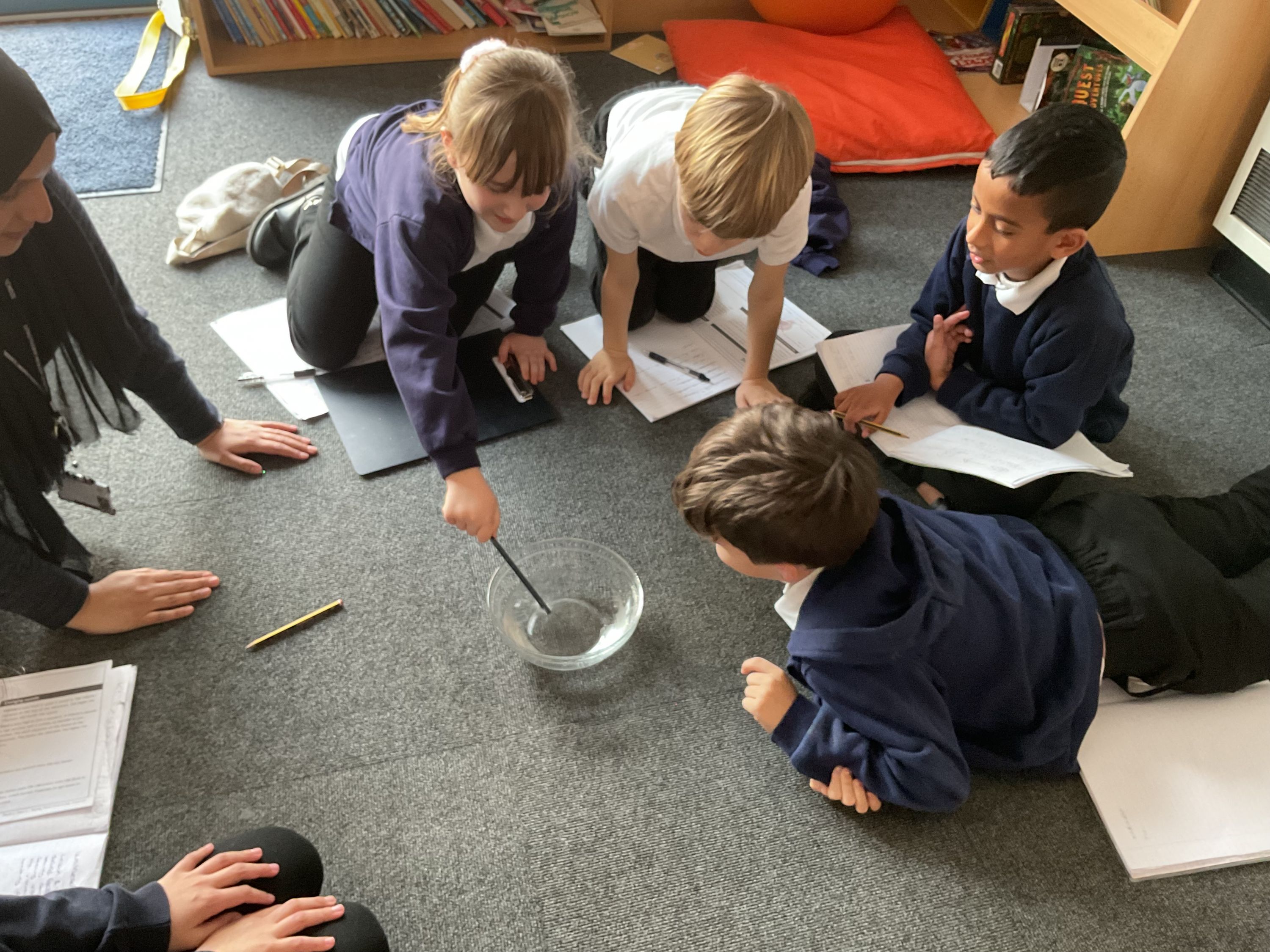 Small group of children working on the floor in a group