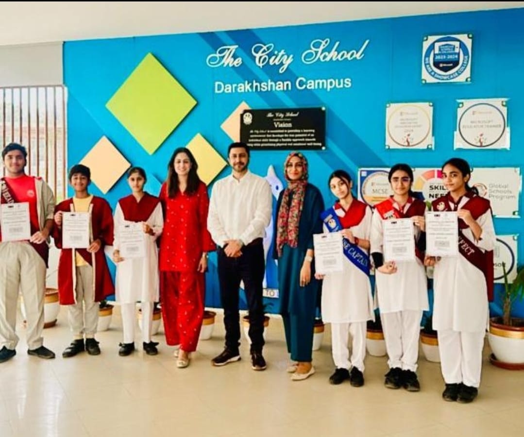 Students from The City School Darakhshan Campus-Prep Section in Pakistan stood holding certificates of collaboration for Pledge Towards Kindness