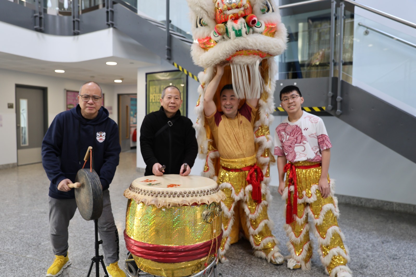 Members of the New Year lion dance performance stand with gong, drum and lion costume
